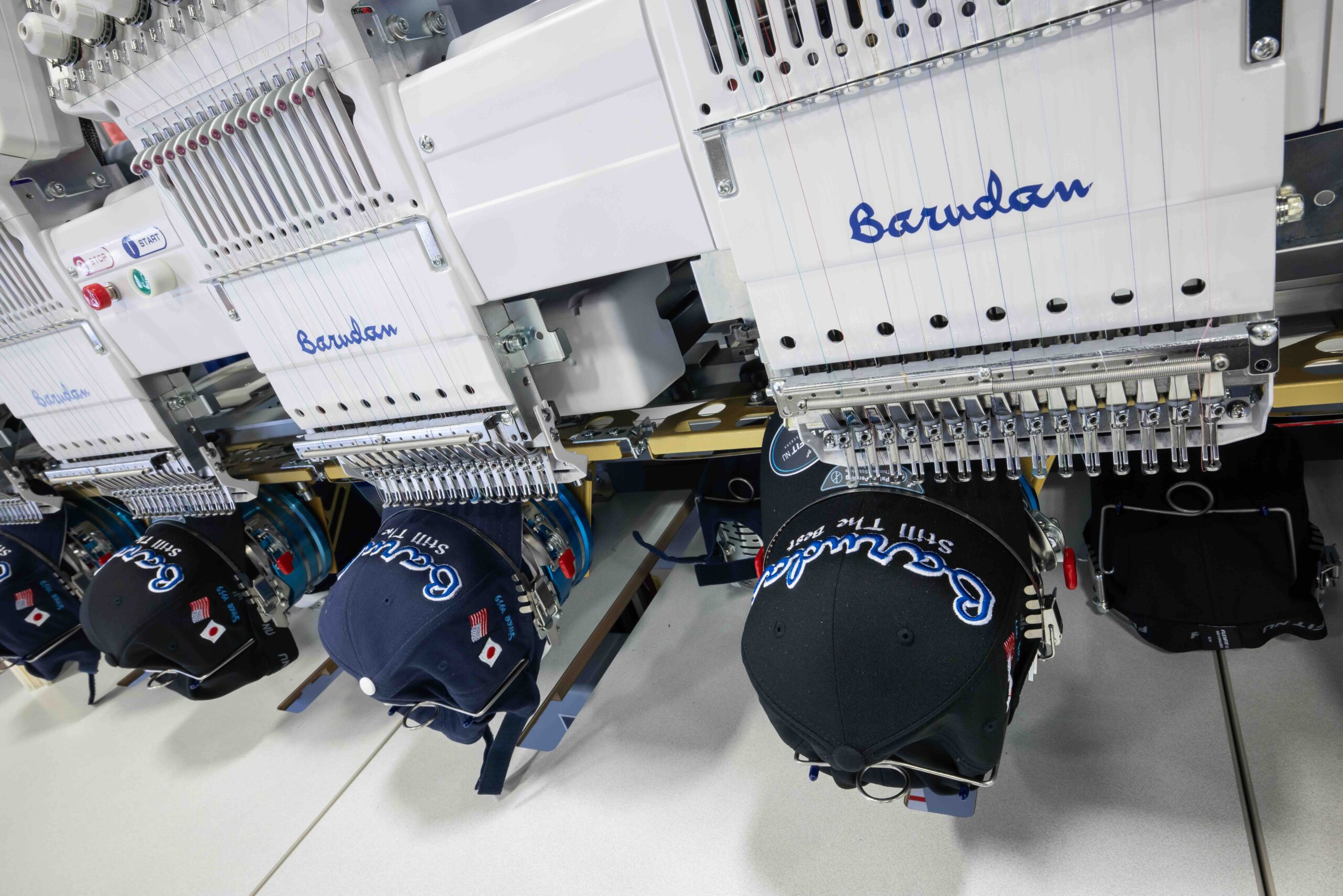 Multi-head commercial embroidery machine and caps
