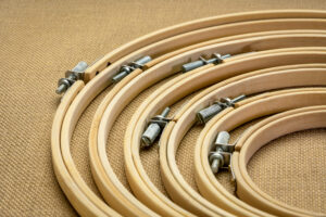 set of bamboo embroidery hoops against burlap canvas, craft and hobby concept