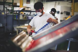 Screen printing press operator decorated apparel shop
