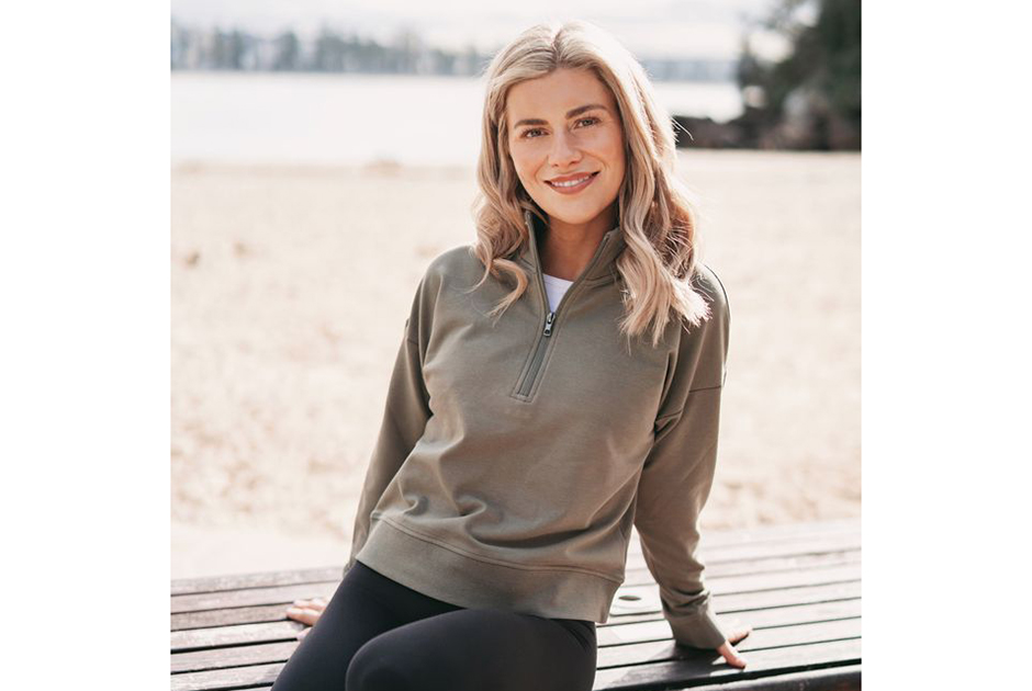 Model wearing Independent Trading Co. EXP15WPQ women’s quarter-zip in smoke color.