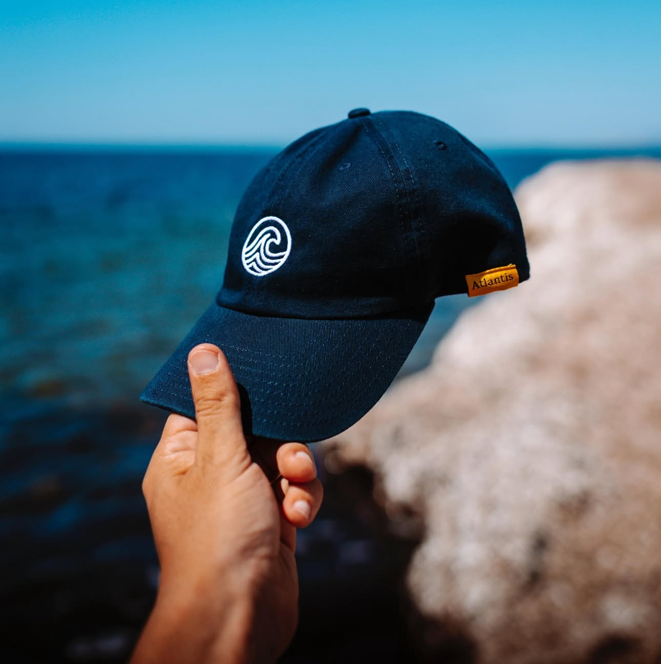 Close-up of Atlantis water-repellent bucket hat and relaxed dad hat