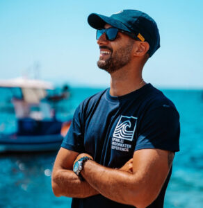 Crew wearing Atlantis hats aboard sailboat in the Egadi Islands.
