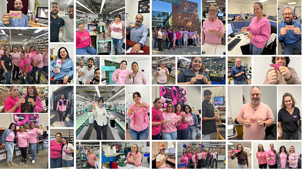 Penn Emblem employees holding pink awareness emblems at company event.