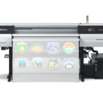 Epson SureColor G9070 64-inch direct-to-film printer producing full-color DTF transfers, designed for high-volume apparel decoration.
