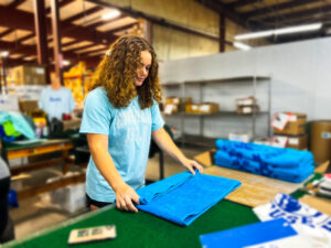 Worker commercial decorated apparel shop using STAHLS Fulfill Engine