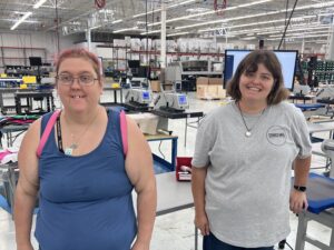 Two workers with disabilities at decorated apparel company Stakes Mfg.
