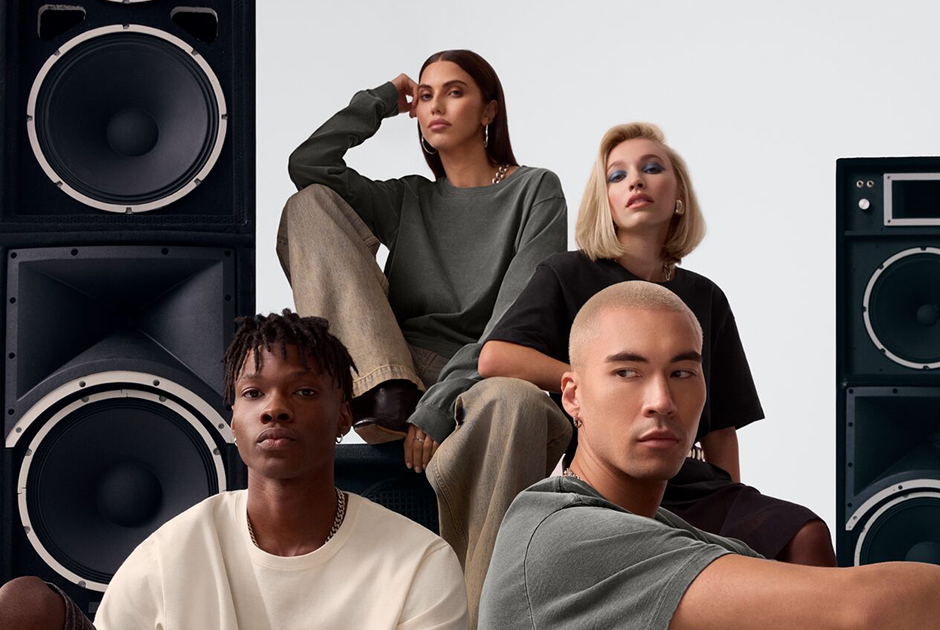 Models wearing premium BELLA+CANVAS blank T-shirts in neutral tones styled in a fashion-forward setting, reflecting festival merchandise trends and Coachella 2026 apparel customization experience.