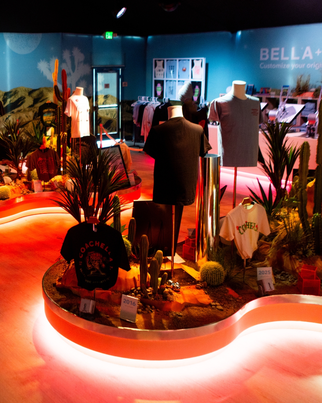BELLA+CANVAS Coachella 2026 Museum of Merchandise activation featuring custom T-shirt displays and immersive festival merch experience