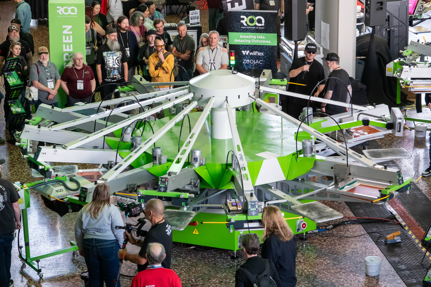 ROQ Automatic custom apparel screen printing press at Impressions Expo decorated apparel industry trade show