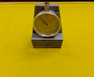 Screen-printing tension meter measuring mesh tension for improved print quality and production consistency.