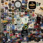 Wall displaying hundreds of embroidered logo samples used to evaluate embroidery digitizing quality, stitch density, lettering clarity and design execution.