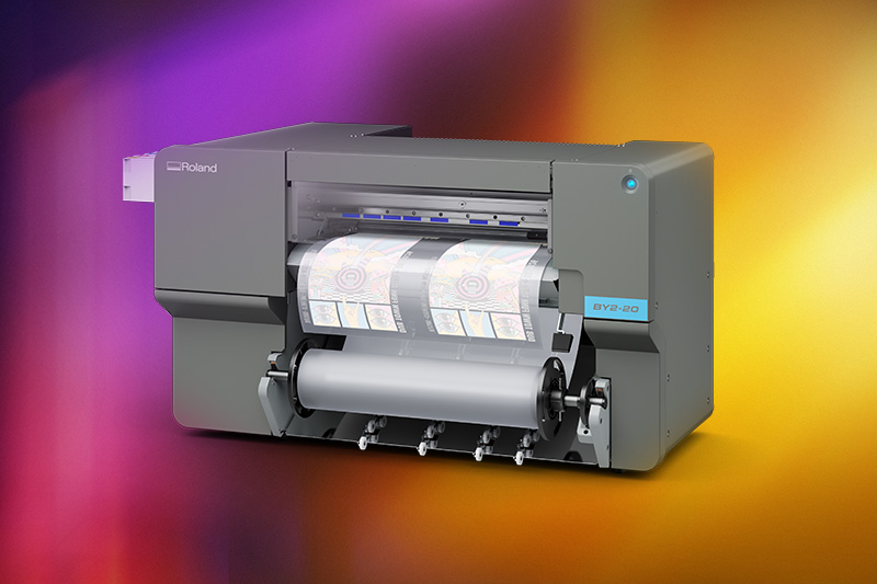 Roland DG VersaStudio BY2-20 desktop direct-to-film printer producing transfer film for apparel decoration applications.