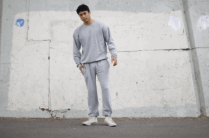 Model wearing Royal Apparel fleece sweatshirt and sweatpants made from premium cotton-blend fabric for comfort, athleisure, and casual lifestyle applications.