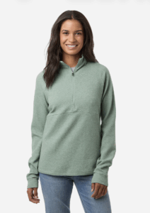 Model wearing S&S Activewear North End women's textured quarter-zip pullover in sage green, showcasing performance fabric and modern women's corporate apparel styling.