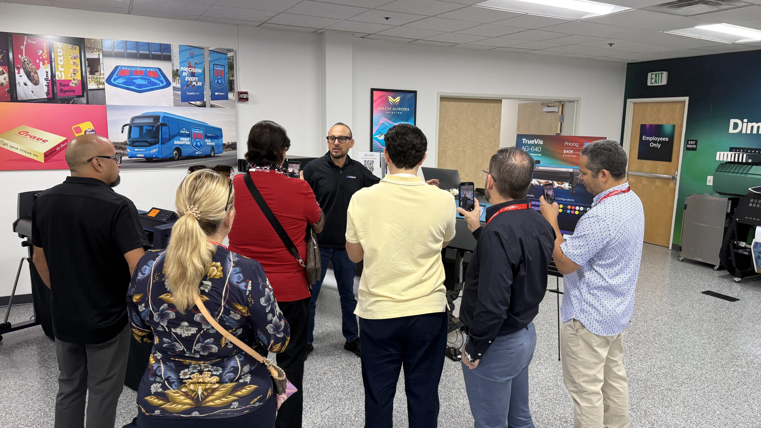 Roland DG Americas open house attendees viewing live digital printing equipment demonstrations at the company’s Irvine headquarters.