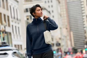 Model wearing a MiiR quilted vest layered over a long-sleeve shirt as part of SanMar's 2026 Fall New Arrivals collection.
