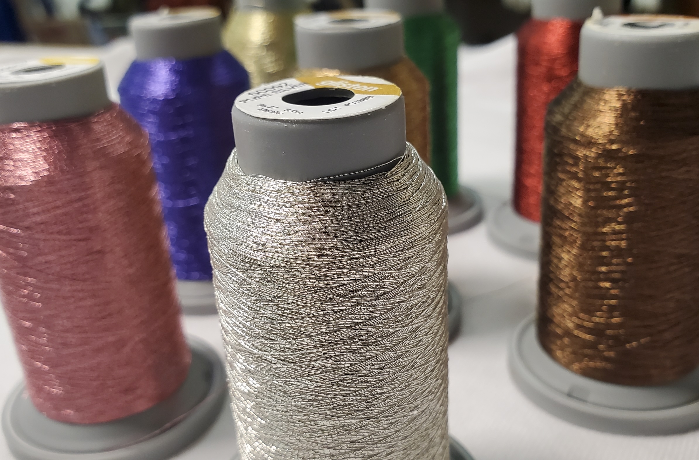 Specialty threads for use in a commercial custom embroidery business