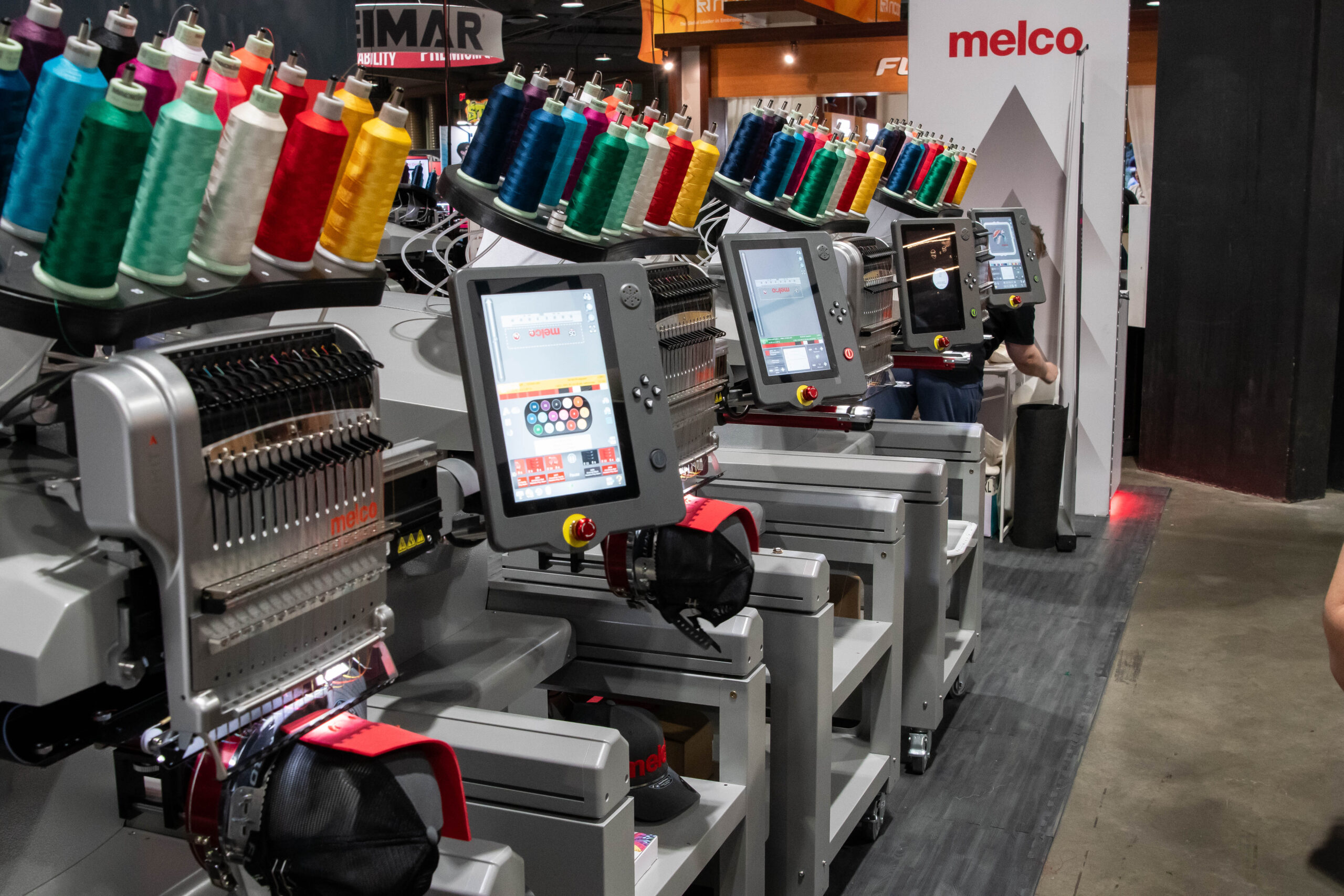 Melco commercial single-head embroidery machines configured for multi-machine apparel production