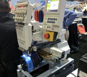 Commercial embroidery machine doing 3D puff embroidery on a cap